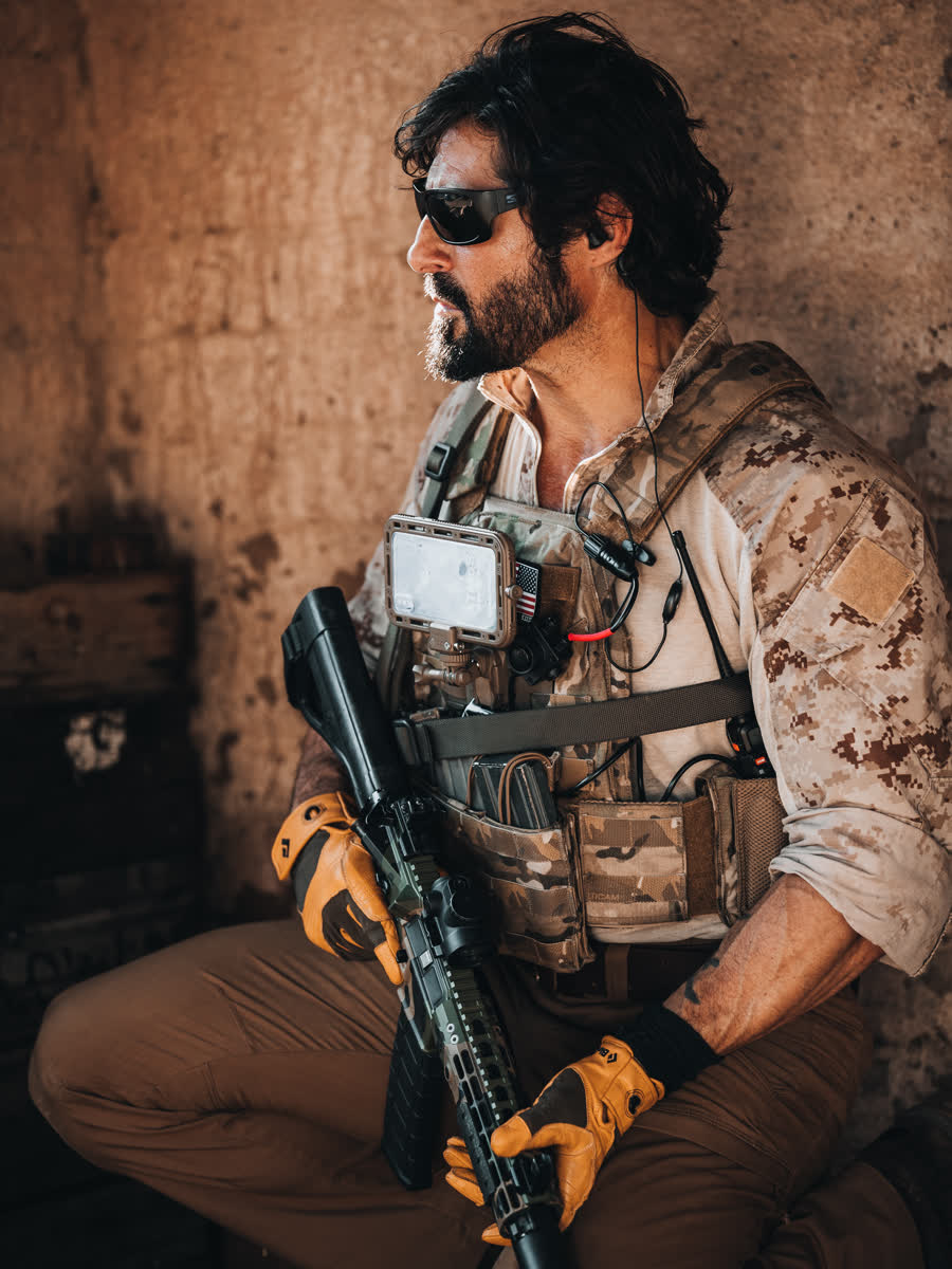 Portrait of an operator with the Atmos case mounted on his chest rig